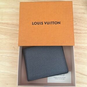 Never used Louis Vuitton men’s wallet. Grey w/JAH initials imprinted on inside.